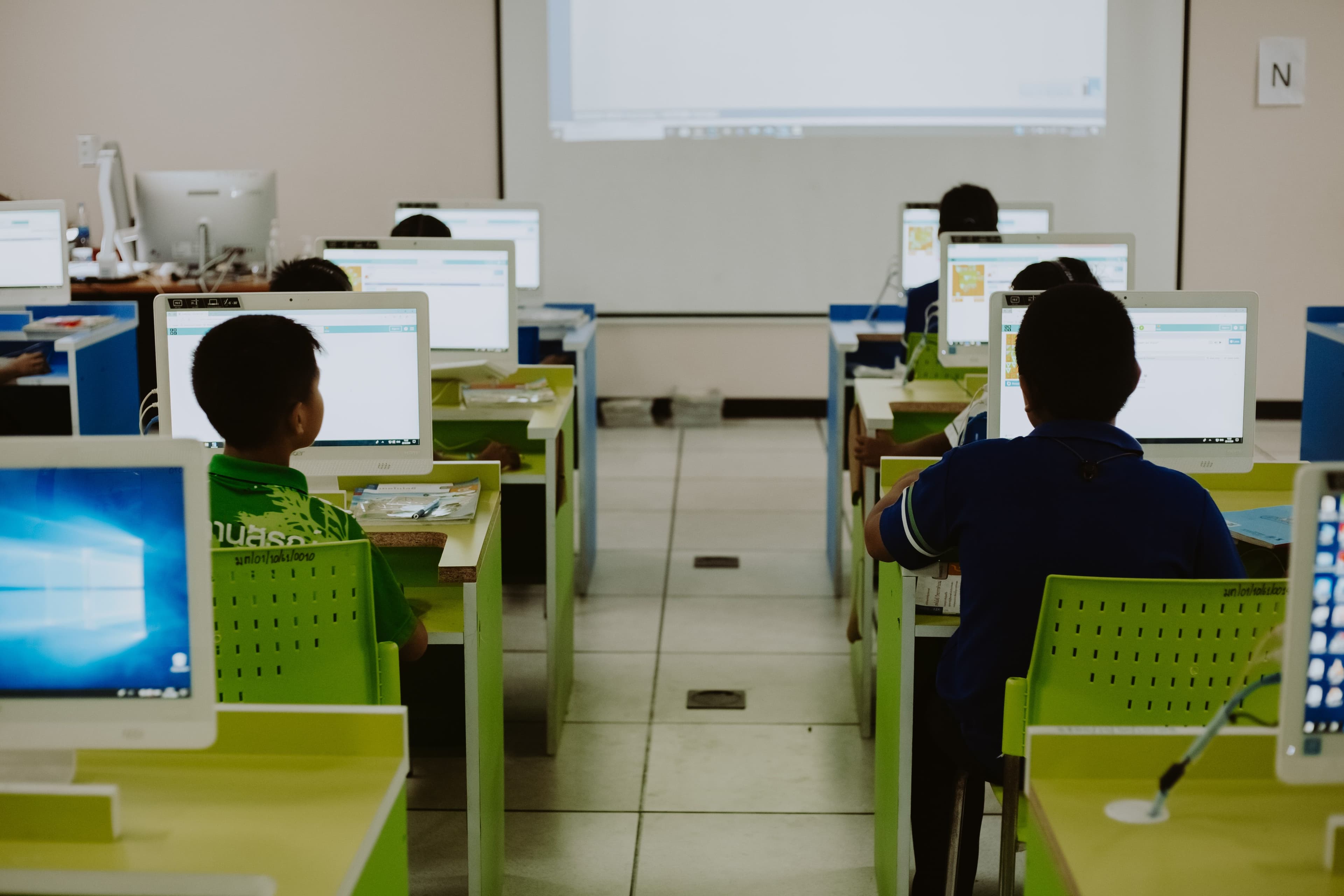Two students working at a computer in a school lab